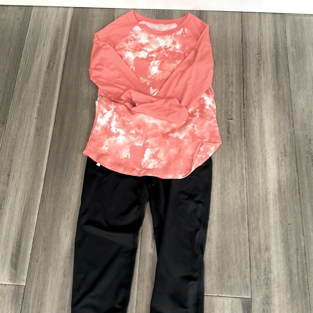 Shirt and pants . Orange and white shirt, black under armor pants